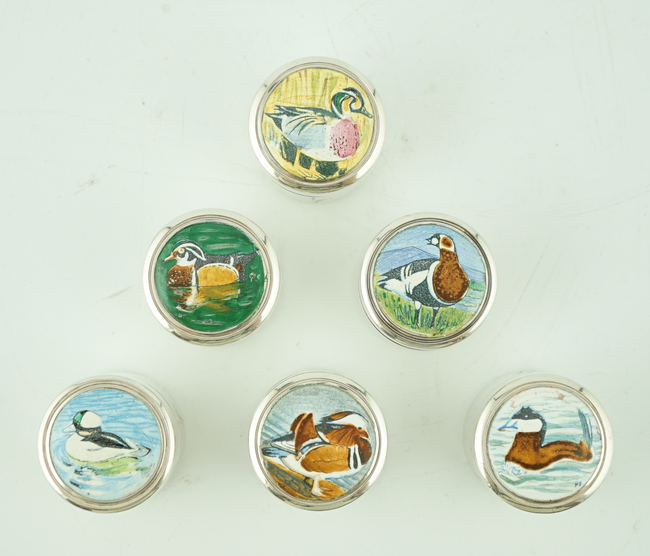 An Elizabeth II set of six limited edition Peter Scott Wildfowl Trust silver and enamel circular pill boxes and covers, by The St James House Company